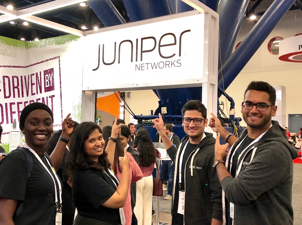 Group of Juniper Networks employees in front of a trade show booth