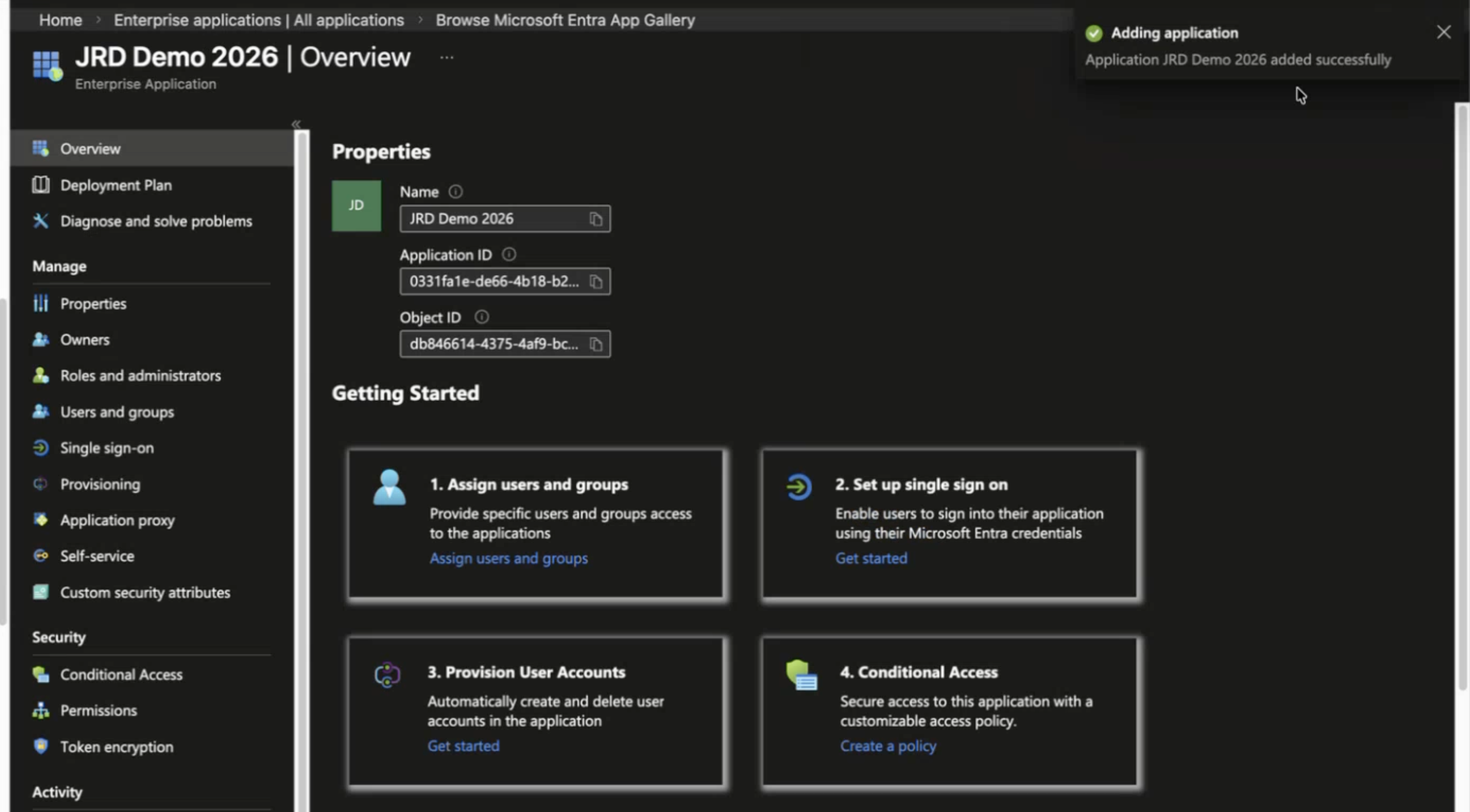 Microsoft Entra Admin Center interface showing the overview page for enterprise application JRD Demo 2026, with navigation menu, application details, and success notification confirming app addition.