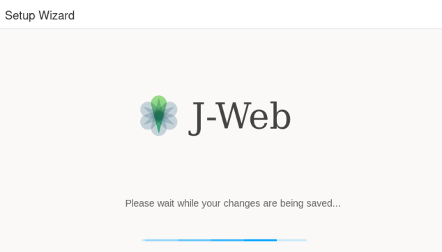 Setup Wizard screen in J-Web saving changes with progress bar indicating operation status.